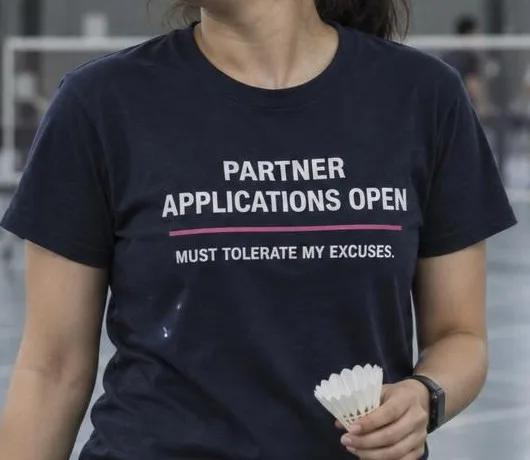 Badminton player wearing PARTNER APPLICATIONS OPEN
