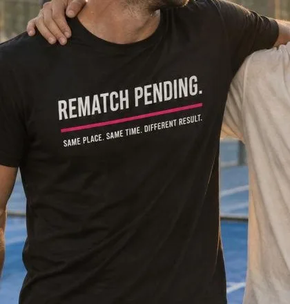 Friends laughing on court, one wearing REMATCH PENDING